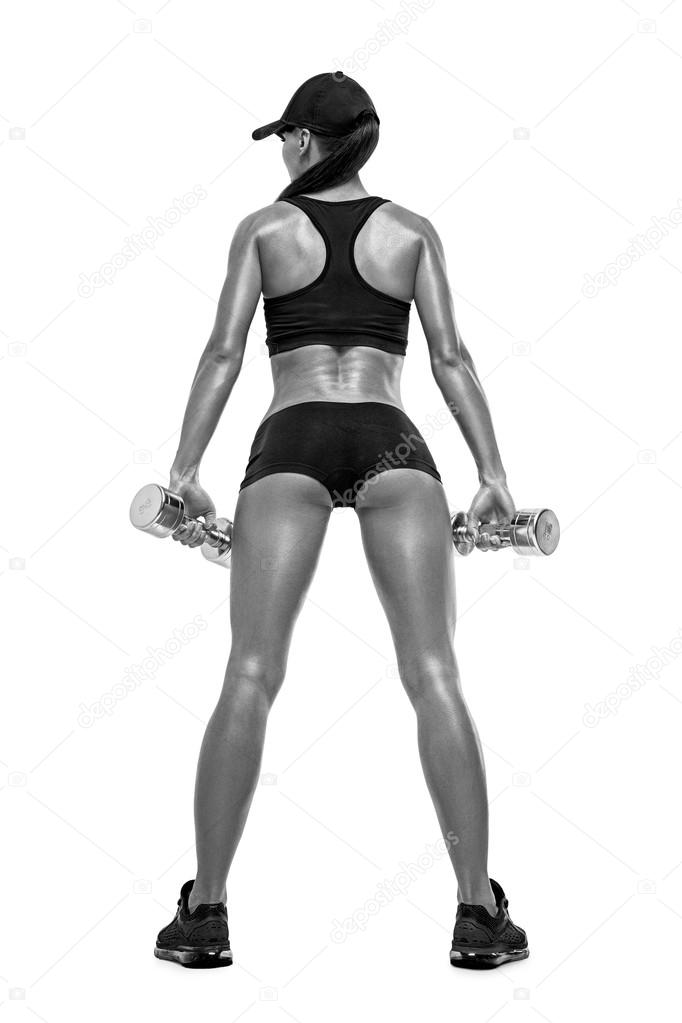 Fitness sporty woman in training pumping up muscles with dumbbel