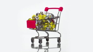 Popular Household Batteries. A grocery cart full of AA batteries rotates slowly on a bright white background