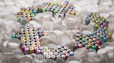 Recycling Symbol in the form of Batteries. Recycling and Recycling Symbol is made up of old AA batteries. It rotates slowly among the white plastic covers filling all the space around