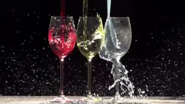 In glasses pouring jet of different colors — Stock Video