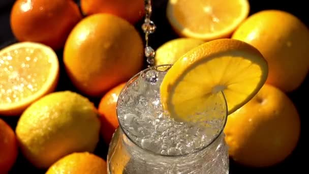 Mineral water poured into glass with orange — Stock Video