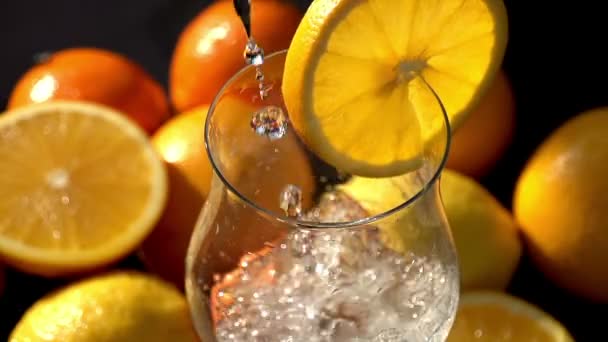 Mineral water poured into glass with orange — Stock Video