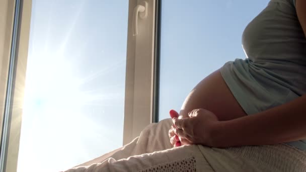 Pregnant woman on window sill — Stock Video
