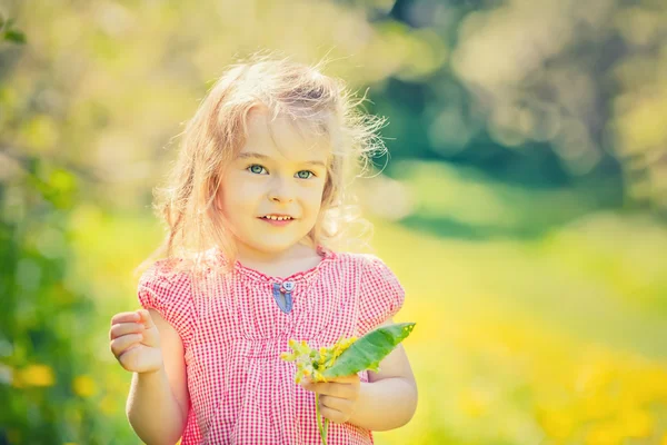 Happy little girl in spring sunny park — Stock Photo, Image