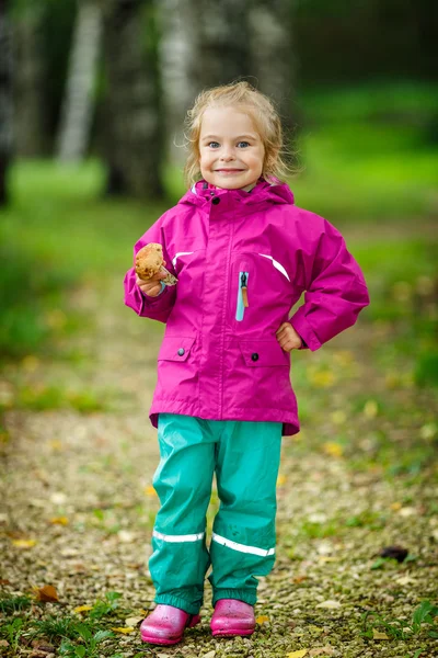 Happy little girl with a mushroom — Stock Photo, Image