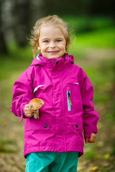 Happy little girl with a mushroom — Stock Photo, Image