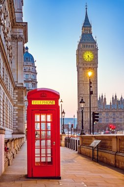 Traditional red phone booth in London clipart