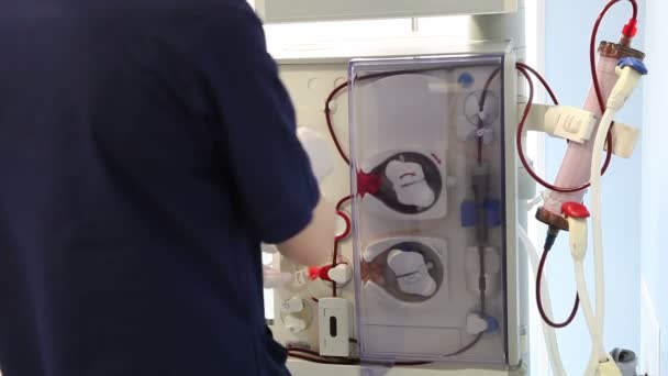 Médico que examina o dispositivo renal artificial — Vídeo de Stock
