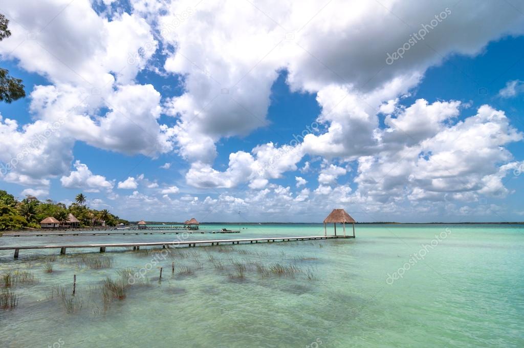 Idyllic pier and palapa hut in Bacalar lagoon in Mexico