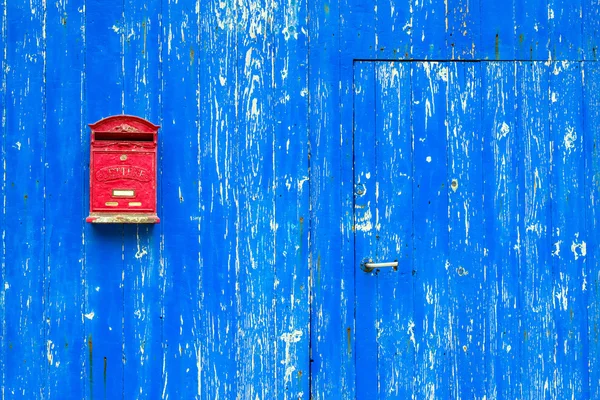 Red mail box on textured wall — Stock Photo, Image