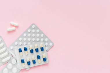İlaç paketleri, pembe arka planda haplar. Sağlıklı yaşam tarzı kavramı. Boşluğu kopyala.