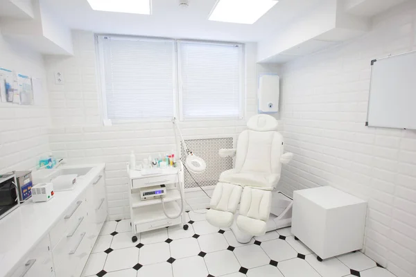 Interior of office of podiatrist, master of medical pedicure and manicure. Beauty salon design in light colors.