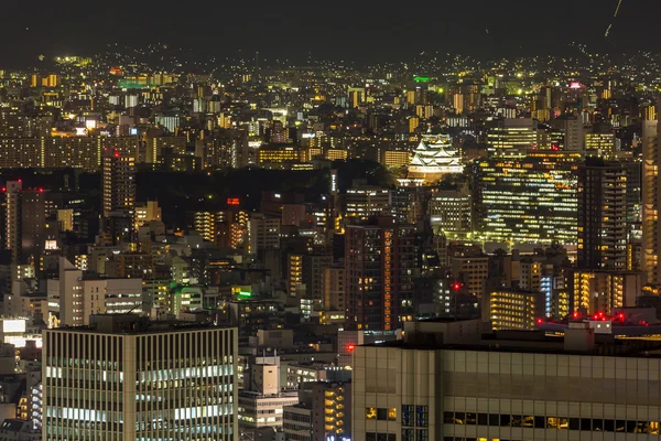 Osaka hrad s panorama budov v noci — Stock fotografie