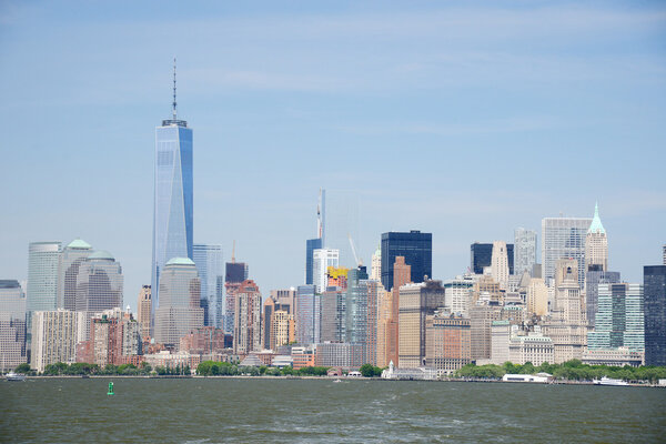 Building and skyline of downtown manhattan during daytime as seen from a boat