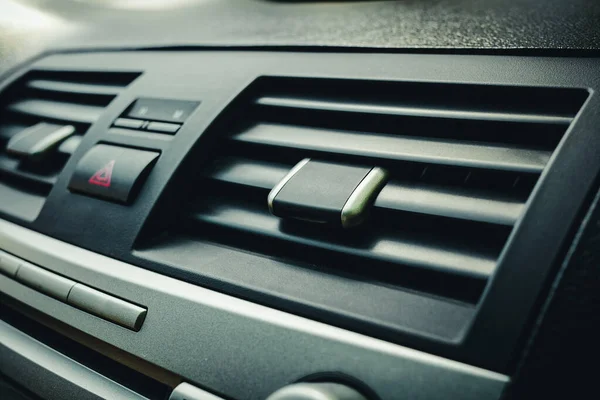 Close-up of the fan or air conditioner grilles in the car interior. Airing the car — Stock Image Close Fan Air Conditioner Grilles Car Interior Airing Car Stock Photo