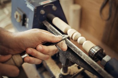 Torna tezgahında çalış. Usta 'nın elleri keskiyle yakın plan çekimde. Ahşap bir parça işleniyor. İş ve işçilik. Marangoz ve Turner 'ın işyeri..