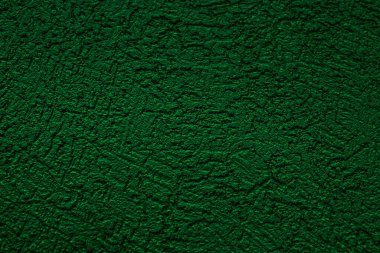 Duvar çiziklerle sıvanmış. Sert bir yüzey. Yeşil rengin soyut arkaplanı. Web sitesi ya da reklam tasarımı için bir şablon.