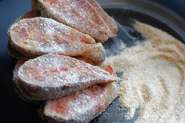 Cocinar platos de pescado. Trozos crudos de salmón rosado o salmón chum en migas de pan están en el plato. —  Fotos de Stock