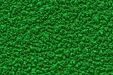 Kaba alçı dokusuna sahip parlak yeşil katı arkaplan. 