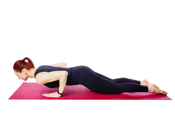 A slender athletic girl does push-ups from her knees on a gym mat.Exercises for the development of the pectoral muscles — Stock Photo, Image