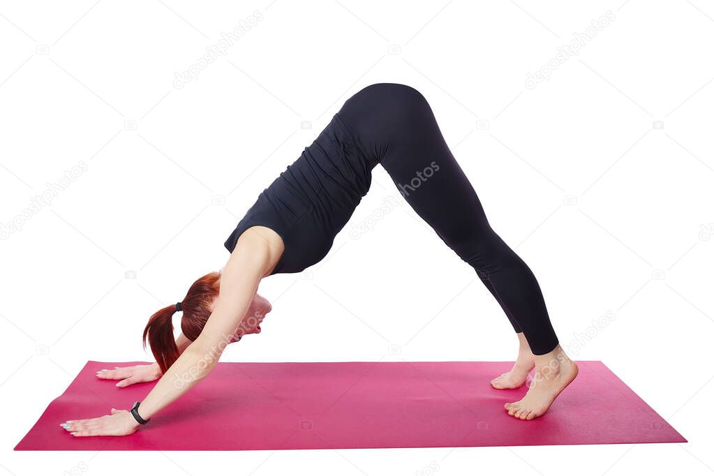 A beautiful slender woman performs a Dolphin exercise on a gym mat. Activation of the transverse abdominal muscle.