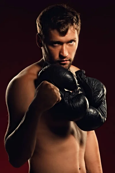 Portrait of a confident fighter on a dark background with a straight and bold look. — Stock Photo, Image