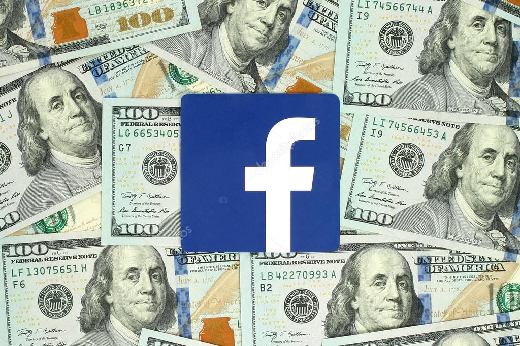 Kiev, Ukraine - June 13, 2016: Facebook logo sign printed on paper and placed on money background. Facebook is a well-known social networking service