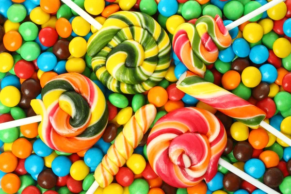 Colorful spiral lollipop with chocolate — Stock Photo, Image