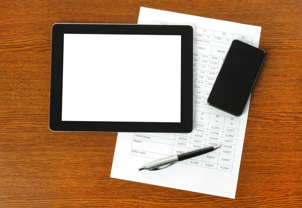 Tablet pc, smart phone and paper with graphs — Stock Photo, Image