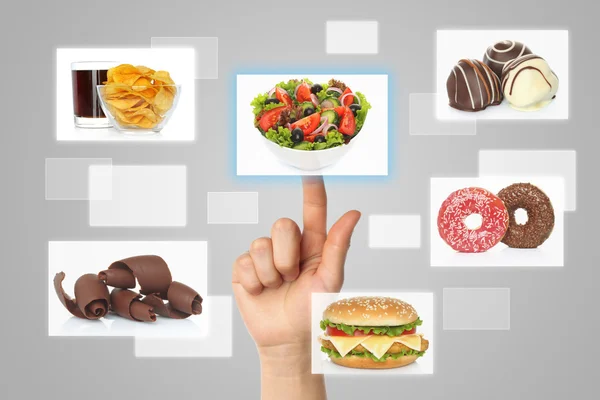 Woman hand uses touch screen interface with food — Stock Photo, Image