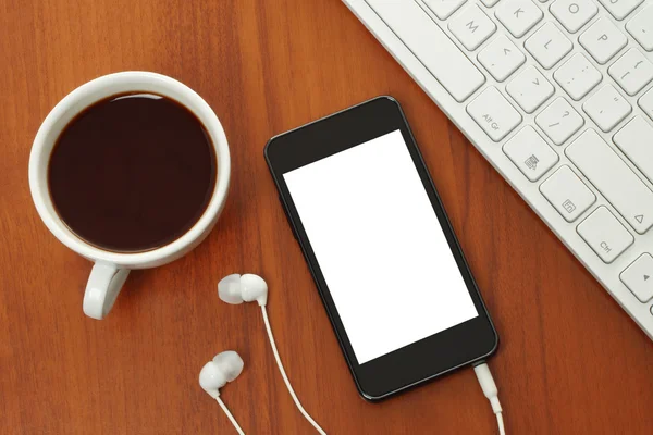 Teléfono inteligente con auriculares, teclado y taza de café —  Fotos de Stock