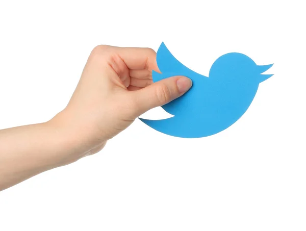 Hand holds twitter logotype bird printed on paper — Stock Photo, Image