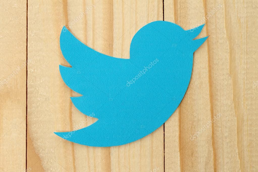 KIEV, UKRAINE - FEBRUARY 19, 2015:Twitter logotype bird printed on paper. Twitter is an online social networking service that enables users to send and read short messages.