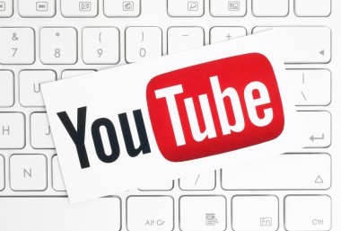 YouTube logotype printed on paper and placed on white keyboard