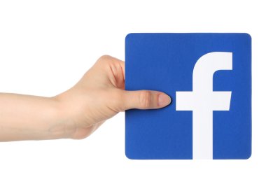 Beyaz arka plan üzerinde kağıt üzerinde yazılı facebook logo el tutar