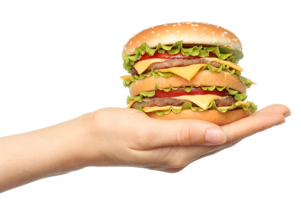 Hand holds big hamburger on white background — Stock fotografie