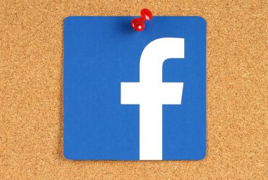Facebook logo sign printed on paper and  pinned on cork bulletin board