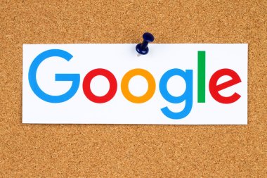 New Google logotype printed on paper, cut and pinned on cork bulletin board