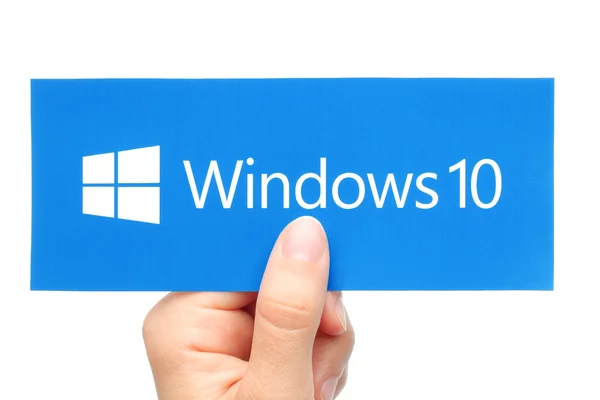 Hand holds Windows 10 logotype printed on paper — Stockfoto