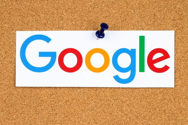 New Google logotype printed on paper, cut and pinned on cork bulletin board Stock Picture