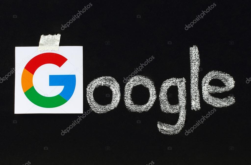 Kiev, Ukraine - September 02, 2015:New Google logotype printed on paper, cut and pasted on blackboard with chalk finish writing.Google is USA multinational corporation.