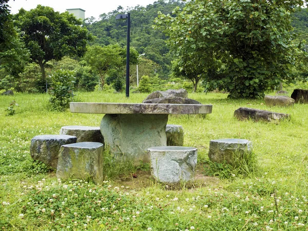 Stone table and seating benches in park — Stock Photo, Image