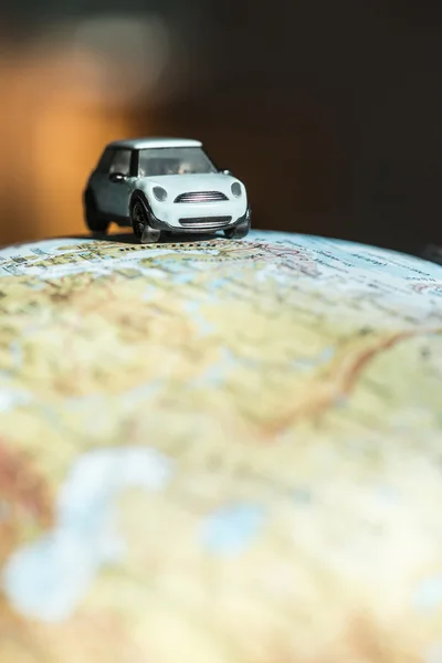 Car figure on globe — Stock Photo, Image