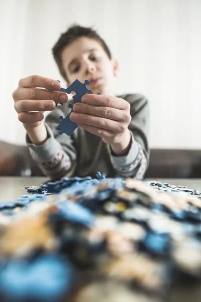 Criança com pilha de quebra-cabeças — Fotografia de Stock