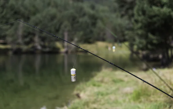 Fishing rods on lake — Stock Photo, Image