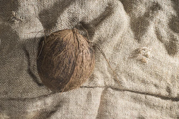 Close up of coconut on burlap — Stock Photo, Image