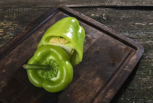 Cut green pepper on wood