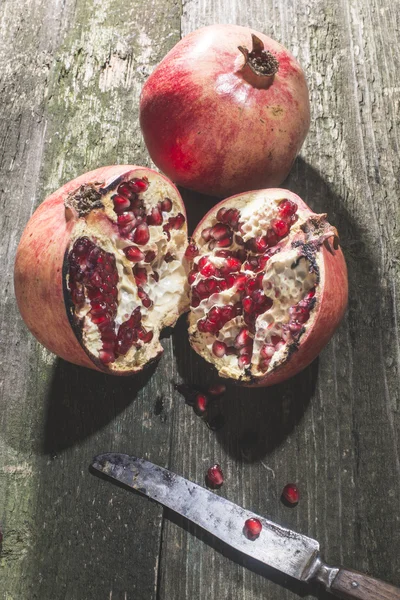 Pomegranate on wooden table — Stock Photo, Image