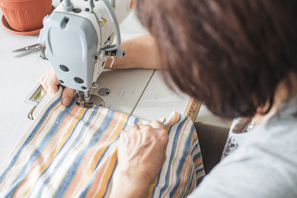 Woman sew on sewing machine