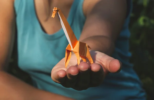 Origami giraffe on hand — Stock Photo, Image